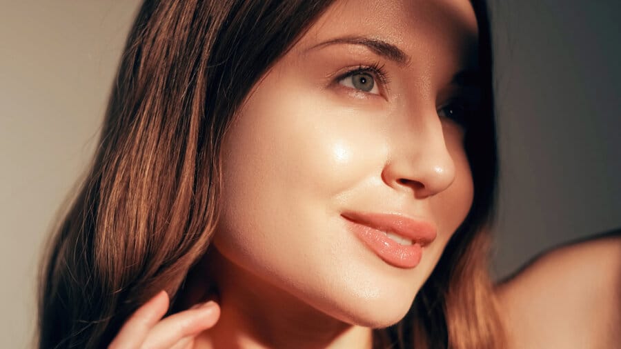 Woman with glowing hydrated skin after Bio Lift Facial treatment featuring glass skin results and radiant complexion.