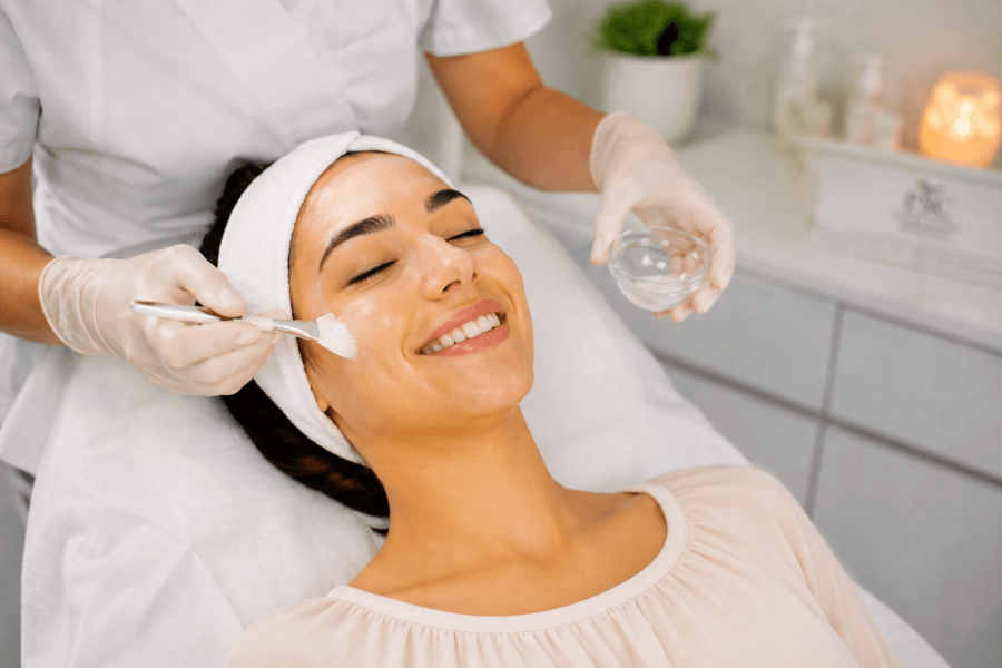 Woman receiving an express facial treatment in a modern clinical spa setting in Fullerton