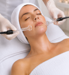 Lymphatic Drainage Facial Massage in Fullerton Woman receiving a lymphatic drainage facial massage during a relaxing skin rejuvenation treatment.