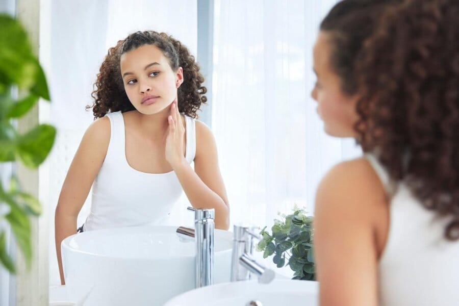 Student preparing for school pictures after a hydrating facial for smooth, healthy-looking skin.